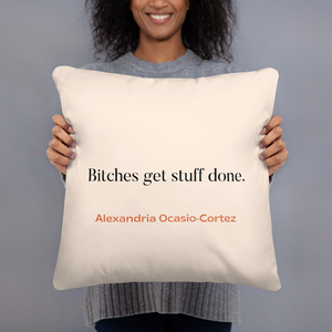 a woman holding a pillow that says bitches get stuff done
