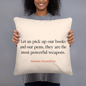 a woman holding a pillow with a quote on it