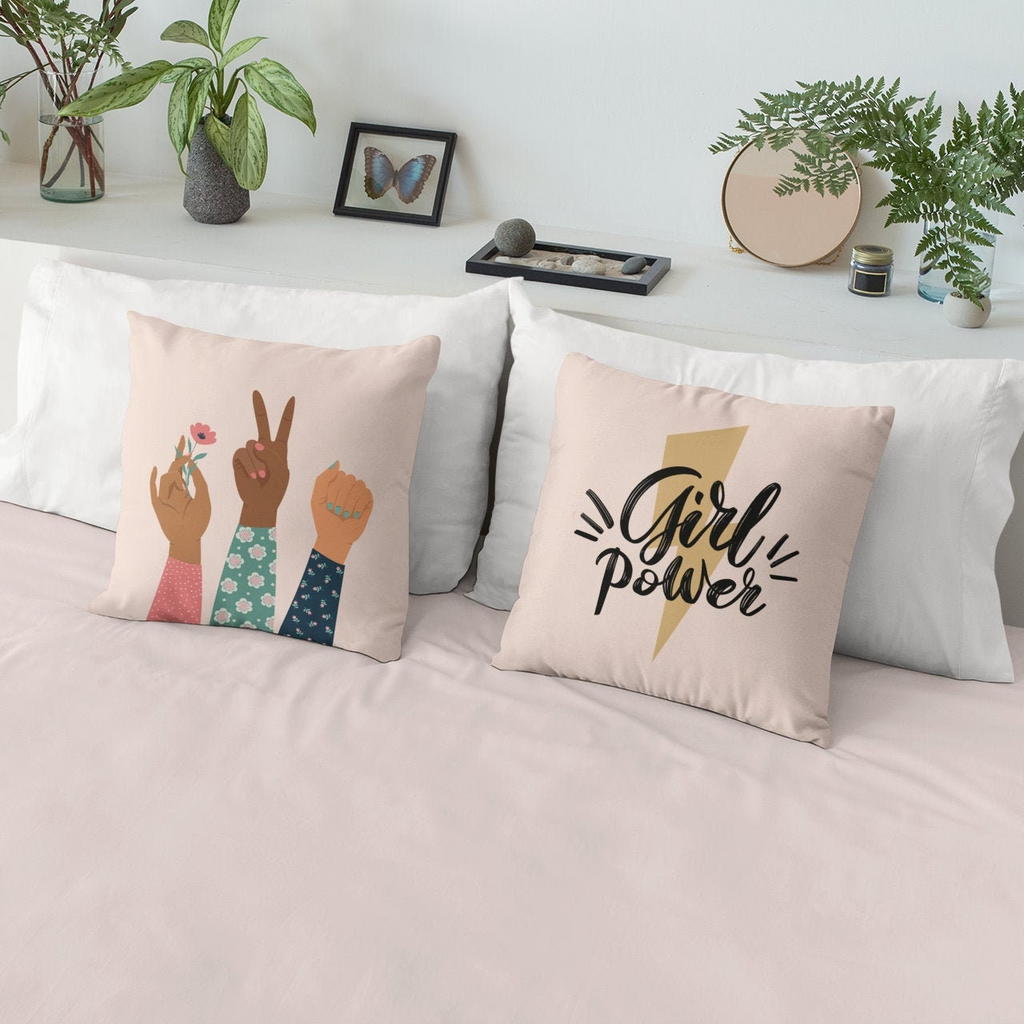 a bed with two pillows that say girl power and a girl power